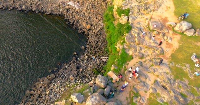 Person ziplining over a scenic waterfall