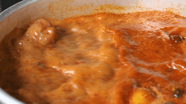 Spicy Chinese broth boiling in pot