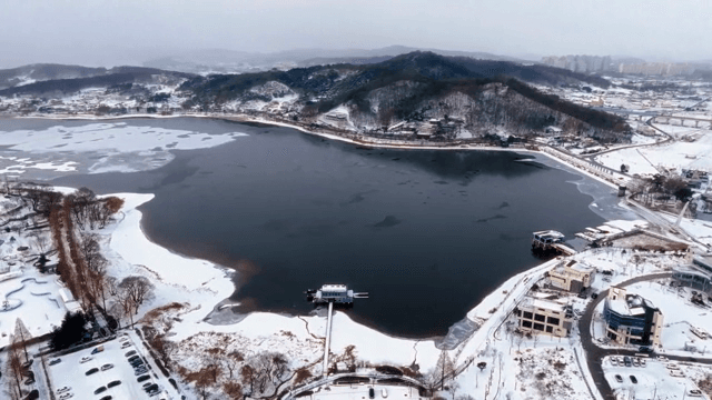 Snow-covered landscape with a frozen lake