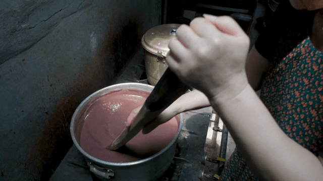 Boiling red bean porridge in a pot on the stove