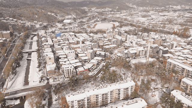 Snow-covered city landscapes, buildings, and roads