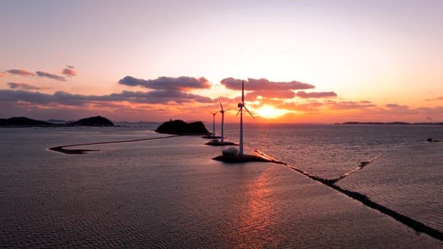 Wind turbines at sea during sunset