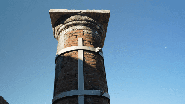 Ancient brick column under clear sky