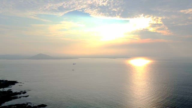 Sunlight shining through the clouds on the sea