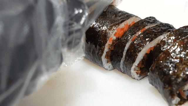 Slicing kimbap with a sharp knife