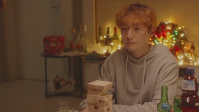 Man playing jenga in cozy room decorated with christmas decorations