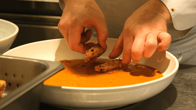 Chef preparing a dish with shrimp