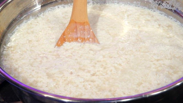 주걱으로 용기 속 콩물 저어주기