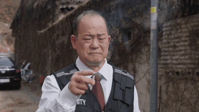 Security guard smoking outside a building
