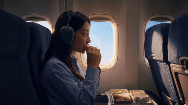 Woman eating sandwich on airplane