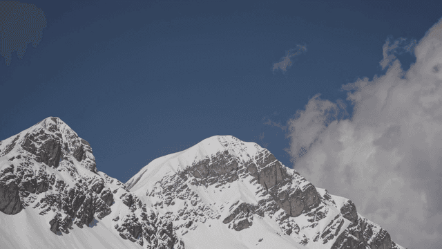 Snow-covered mountains under a clear sky