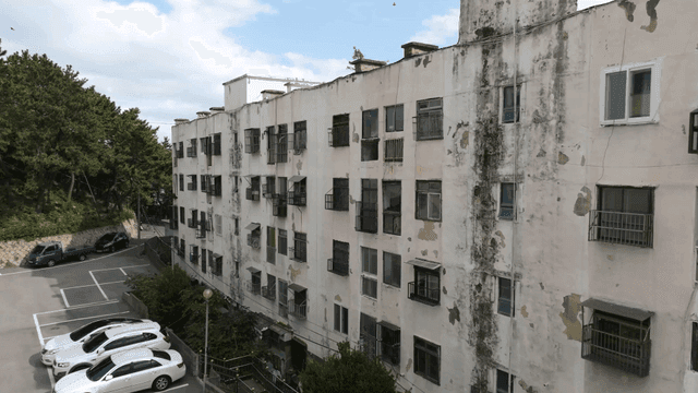 Old apartment building with parked cars