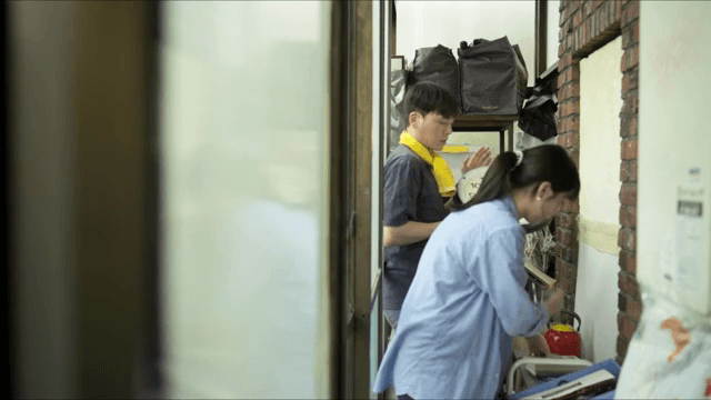 Two people organizing items indoors