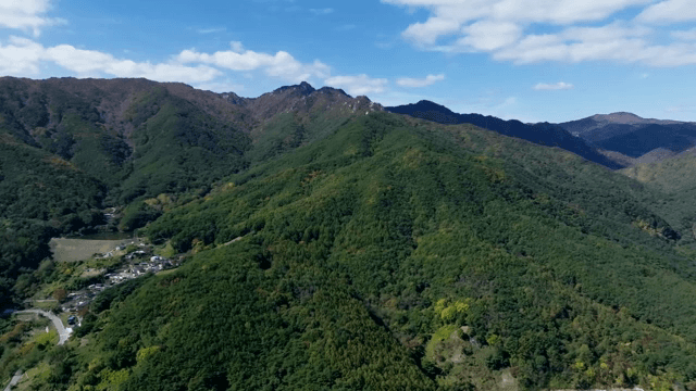 Green mountains under a clear sky