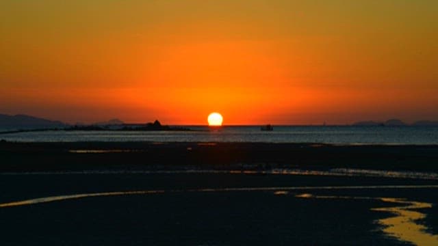 Serene and Red Sunset Over Calm Seaside