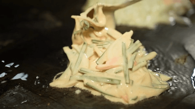 Vegetable pancake batter on a hot griddle