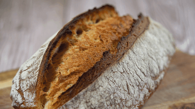 Freshly baked loaf of bread on a wooden board