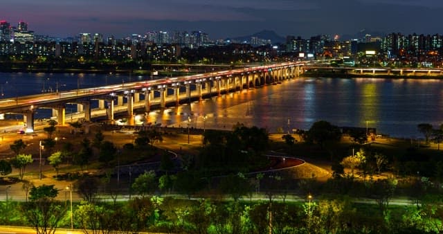Seoul cityscape at night with Han River bridge
