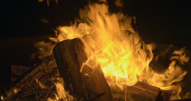 Brightly Burning Flame Attached to Thick Firewood