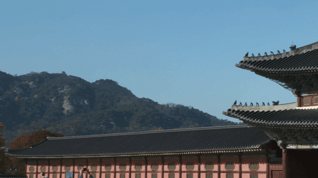 Traditional Korean palace with mountains