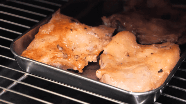 Chicken baking on oven tray