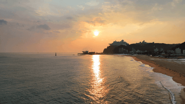 Quiet beach where boat-shaped hotel is visible at sunrise