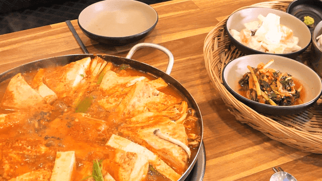 Kimchi stew boiling with side dishes