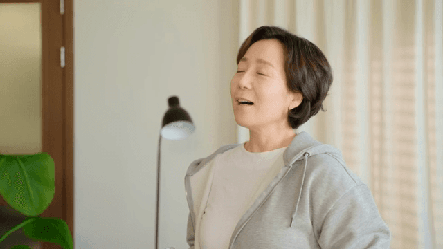 Woman drinking water and checking watch