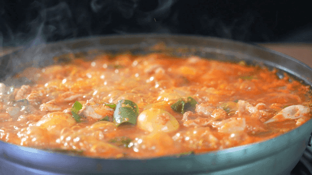 Spicy chicken offal stew boiling in pot