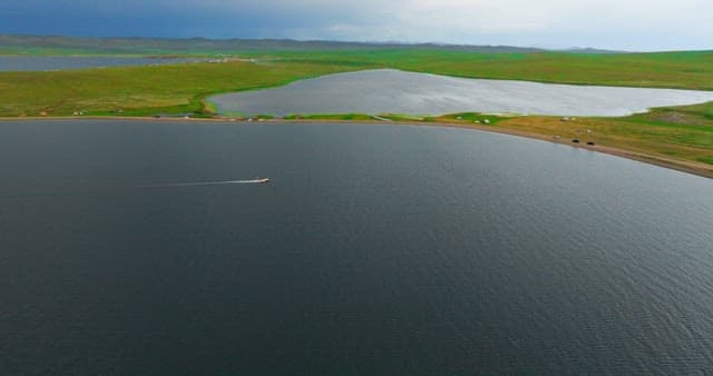 Boat cruising on a vast lake