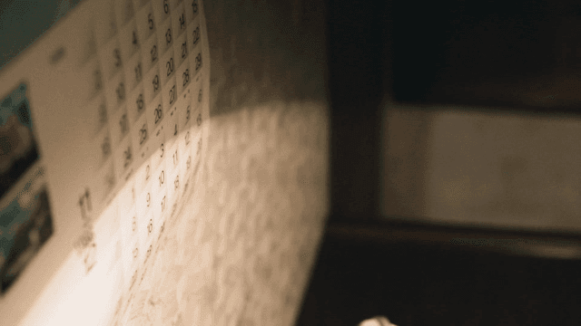 1986 calendar on darkly lit wall