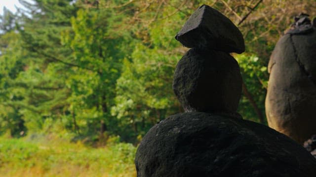 Rock tower surrounded by trees and greenery