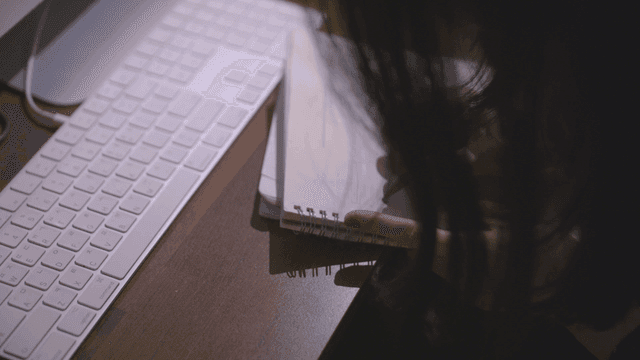 Person who draws musical notes in notebook