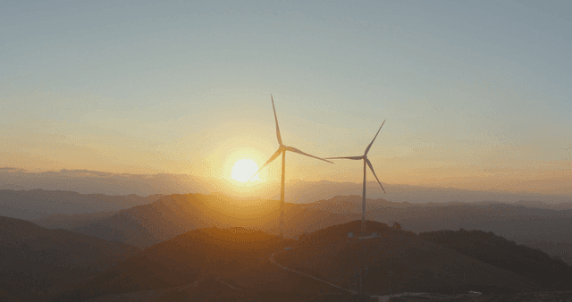 Sunrise and wind turbines on the mountain
