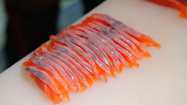 Slicing fresh trout on a cutting board