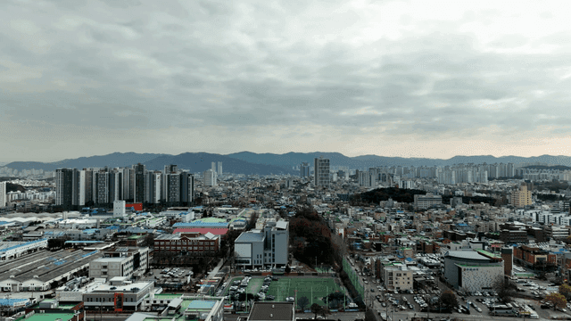 City landscape spread out beneath cloudy sky