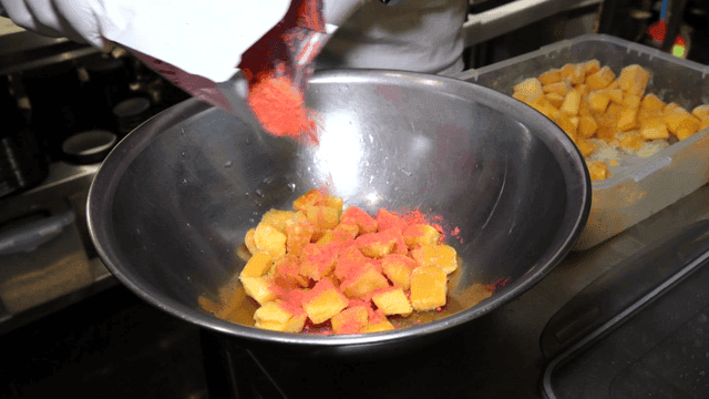 Mango pieces mixed into strawberry powder