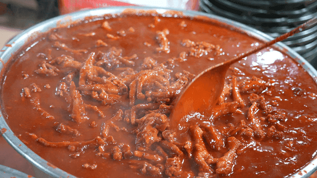 Huge pot full of boiling spicy chicken feet