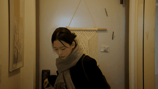 Woman opens front door and enters house