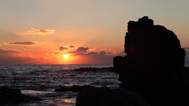 Sunset Behind the Silhouette of Rocky Cliffs