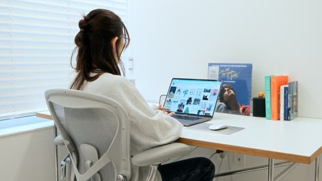 Adult Woman Browsing on Laptop Indoors