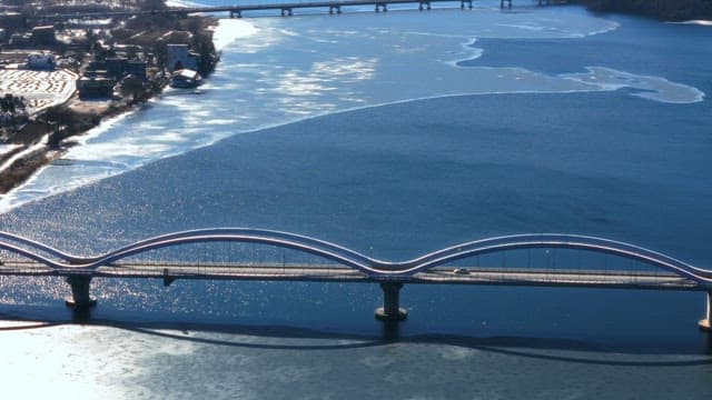 Aerial View of a Bridge Over Frozen River