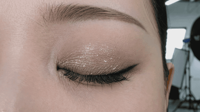 Close-up of a closed eye with glittery makeup