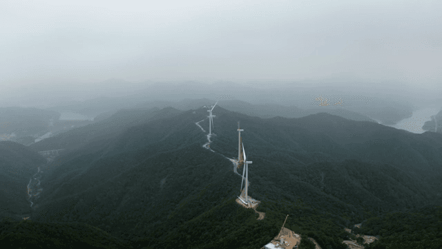 Wind turbines on a misty mountain range