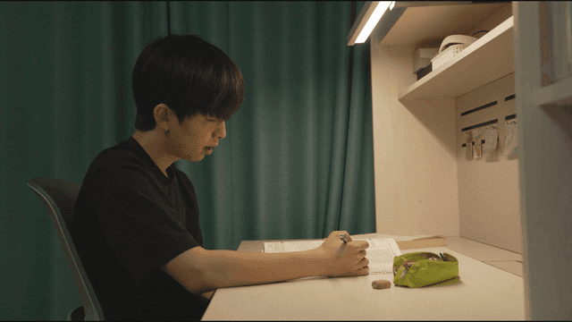 Profile of man crying while studying at his desk