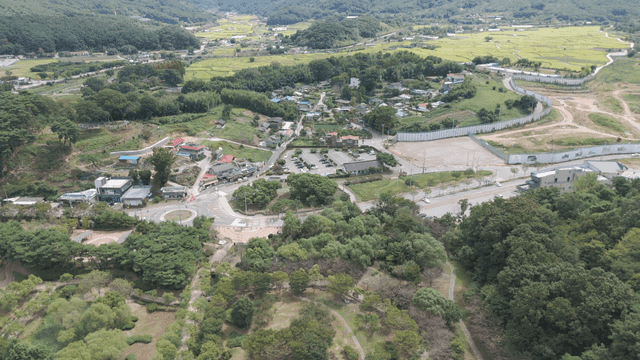 Rural village intersection surrounded by green forest