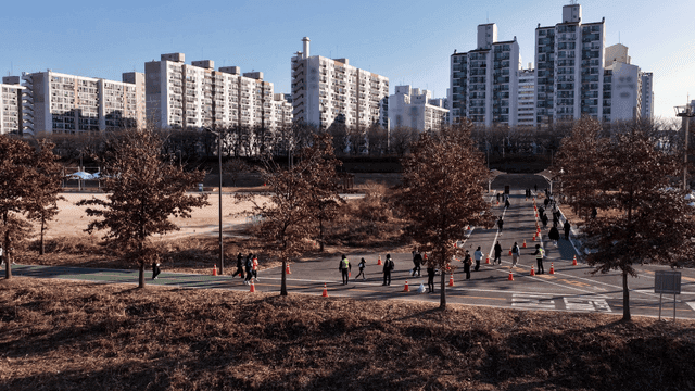 People running in park near high-rise apartment