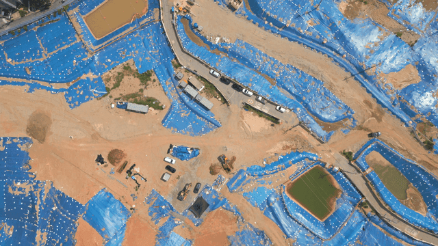 Construction site covered with blue tarps