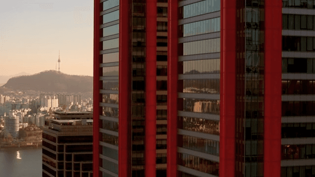 Cityscape with a red skyscraper and tower