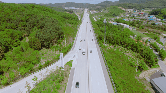 A highway surrounded by lush green hills